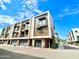 Modern condo exterior with balcony, front entry, attached garage, sidewalk and landscaping at 3233 N 70Th St # 1006, Scottsdale, AZ 85251