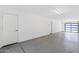 Spacious, unfinished garage with epoxy floors and a modern glass-paneled garage door at 3233 N 70Th St # 1006, Scottsdale, AZ 85251