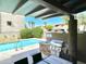 A community grilling area with BBQ, sink, and seating located adjacent to the community pool at 3233 N 70Th St # 1006, Scottsdale, AZ 85251