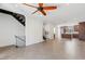 Open-concept living space with modern staircase, tile flooring, and a glimpse of the kitchen at 3233 N 70Th St # 1006, Scottsdale, AZ 85251
