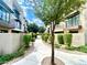 A landscaped walkway with mature trees and bushes connecting the community's residences at 3233 N 70Th St # 1006, Scottsdale, AZ 85251