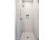 Close-up of shower stall featuring white tile with a decorative pattern and niche for storage at 3233 N 70Th St # 1006, Scottsdale, AZ 85251