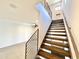 Modern staircase with open risers and metal railing, connecting to a bright and airy living space at 3233 N 70Th St # 1006, Scottsdale, AZ 85251