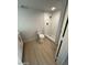 Bright bathroom featuring a tiled shower, toilet, wood-look flooring, and a modern vanity at 349 E Thomas Rd # E301, Phoenix, AZ 85012