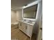 Well lit bathroom featuring double sink vanity with white countertop, lighted mirror, shower and tub at 349 E Thomas Rd # E301, Phoenix, AZ 85012