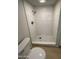 Close-up of the shower with white tiles and a mosaic shower floor in the newly renovated bathroom at 349 E Thomas Rd # E301, Phoenix, AZ 85012