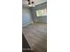 A spacious bedroom with a ceiling fan, plush plank flooring, and a window at 349 E Thomas Rd # E301, Phoenix, AZ 85012