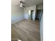 A bright bedroom featuring a ceiling fan, plank flooring and a mirrored closet at 349 E Thomas Rd # E301, Phoenix, AZ 85012