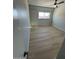 The spacious bedroom features a light ceiling fan, large window, and new plank flooring at 349 E Thomas Rd # E301, Phoenix, AZ 85012