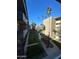 Apartment courtyard with walkways, lawn, mature trees, and palm trees on a clear day at 349 E Thomas Rd # E301, Phoenix, AZ 85012