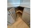 Pantry cabinet with rotating shelving, gray cabinets, and light wood floors at 349 E Thomas Rd # E301, Phoenix, AZ 85012