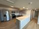 Modern kitchen with stainless steel appliances, ample counter space, and wood floors at 349 E Thomas Rd # E301, Phoenix, AZ 85012