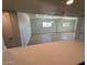 Living room viewed from kitchen with wood floors and neutral paint at 349 E Thomas Rd # E301, Phoenix, AZ 85012