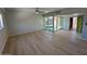 Living room featuring wood floors, with an entry door and view of the enclosed porch at 349 E Thomas Rd # E301, Phoenix, AZ 85012