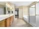 Neutral-toned bathroom featuring a double vanity, soaking tub, and glass shower at 3663 S Soho Ln, Chandler, AZ 85286