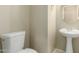 Cozy bathroom featuring a pedestal sink and toilet in neutral tones at 3663 S Soho Ln, Chandler, AZ 85286