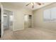 Neutral bedroom with mirrored closet, ceiling fan, and easy access to en suite bathroom at 3663 S Soho Ln, Chandler, AZ 85286