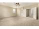 Neutral-toned bedroom with a ceiling fan, carpet, and an ensuite bathroom at 3663 S Soho Ln, Chandler, AZ 85286