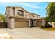 Two-story home features three-car garage, neutral stucco, desert landscaping and clear sky at 3663 S Soho Ln, Chandler, AZ 85286