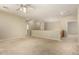 The large, neutral-toned loft space features a ceiling fan and carpet flooring at 3663 S Soho Ln, Chandler, AZ 85286