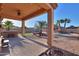 Inviting covered patio overlooks a beautiful backyard with pool, spa, and fire pit at 37262 W Oliveto Ave, Maricopa, AZ 85138