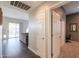 Hallway leading to the living room and featuring an office room with carpet floors at 37262 W Oliveto Ave, Maricopa, AZ 85138