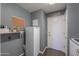 Laundry room featuring a freezer, shelves and a door leading to the outside at 37262 W Oliveto Ave, Maricopa, AZ 85138