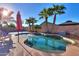 Gorgeous pool with tanning ledge, mature palms, and umbrella for shade at 37262 W Oliveto Ave, Maricopa, AZ 85138