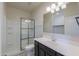 Well-lit bathroom with a shower, vanity, and essential fixtures at 37714 W Capri Ave, Maricopa, AZ 85138