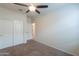 Bedroom with carpet flooring, ceiling fan, and a closet for storage needs at 37714 W Capri Ave, Maricopa, AZ 85138