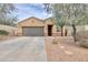 Inviting single-story home featuring a desert landscape and a spacious two-car garage at 37714 W Capri Ave, Maricopa, AZ 85138