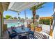 Outdoor living space with pergola, dining set, lush landscaping, and a private pool at 3802 E Shaw Butte Dr, Phoenix, AZ 85028
