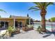 Backyard featuring a covered patio, lush vegetation, a tall palm tree, and a fenced pool area for privacy at 3802 E Shaw Butte Dr, Phoenix, AZ 85028