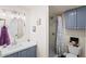 Modern bathroom featuring a stylish vanity, sink, and a shower with decorative curtain and blue accent at 3802 E Shaw Butte Dr, Phoenix, AZ 85028