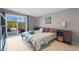 Cozy bedroom featuring a king bed, light floors, and a sliding door leading to a landscaped yard at 3802 E Shaw Butte Dr, Phoenix, AZ 85028