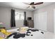 Well-lit bedroom boasts a ceiling fan, a large window, and a wardrobe with closet at 3802 E Shaw Butte Dr, Phoenix, AZ 85028