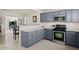 Modern kitchen featuring blue cabinets, stainless steel appliances, and light countertops at 3802 E Shaw Butte Dr, Phoenix, AZ 85028