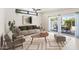 Bright living room with modern furniture, stylish rug, and large sliding doors to the backyard at 3802 E Shaw Butte Dr, Phoenix, AZ 85028
