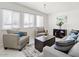 Bright living room with large windows, gray sofa, armchairs, decorative pillows, and chic decor at 3802 E Shaw Butte Dr, Phoenix, AZ 85028