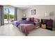 Inviting main bedroom with sliding glass door and outdoor access featuring a stylish purple comforter at 3802 E Shaw Butte Dr, Phoenix, AZ 85028