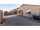 View of the spacious backyard with block wall fencing, covered patio, and room for entertaining at 45 S 238Th Dr, Buckeye, AZ 85396