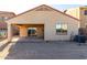 View of the backyard featuring a covered patio, dirt landscaping, and AC unit at 45 S 238Th Dr, Buckeye, AZ 85396