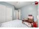 Bright bedroom featuring a full-sized bed, sliding closet doors, and a neutral color scheme at 45 S 238Th Dr, Buckeye, AZ 85396