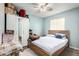 Well-lit bedroom with a full-sized bed, wardrobe with mirror, and a neutral color scheme at 45 S 238Th Dr, Buckeye, AZ 85396