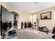 Spacious bonus room with access to the kitchen, carpeted flooring, and a ceiling light at 45 S 238Th Dr, Buckeye, AZ 85396