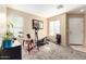 Versatile bonus room with natural light, carpeted flooring, and a ceiling light at 45 S 238Th Dr, Buckeye, AZ 85396