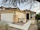 Charming two-story home features a well-manicured front yard and an attached two-car garage at 45 S 238Th Dr, Buckeye, AZ 85396