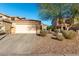 Tan single-Gathering home featuring desert landscaping, large driveway and an attached two car garage at 45 S 238Th Dr, Buckeye, AZ 85396
