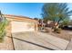 Two-story home with a spacious driveway, mature landscaping, and a two-car garage at 45 S 238Th Dr, Buckeye, AZ 85396
