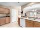 Eat-in kitchen with light wood cabinets, laminate countertops, and white appliances at 45 S 238Th Dr, Buckeye, AZ 85396